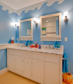 Underwater-world-theme-on-the-walls-with-unique-cabinets-turns-this-bathroom-into-a-world-of-fun